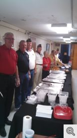 Knights Dave Johnston and Scott Krantz (from left) along with American Legion members stand ready to serve the Thanksgiving dinner.