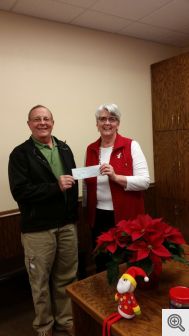 Murray Claassen presents a check to Corinne White, of Good Samaritan