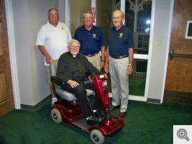 Standing behind Monsignor (l-r): Dan Murphy, Scott Krantz, and Bob Honzik. 