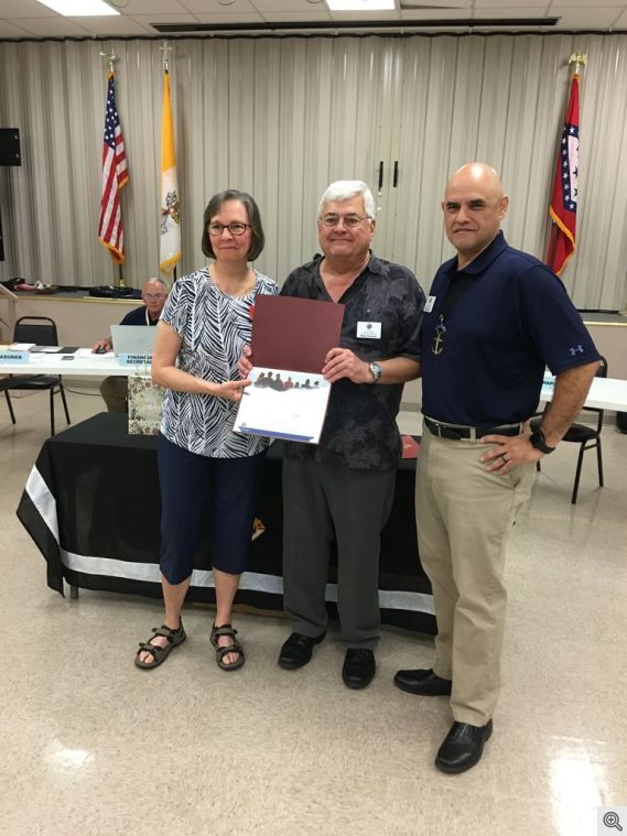 Rick and Sandy Darnell receiving the September Family of the Month Award from Rich Rivera