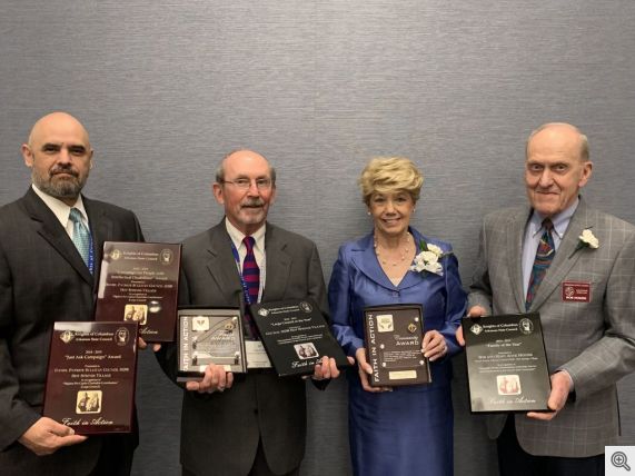 Pictured above from the left, Deputy Grand Knight Rich Rivera holds the "Just Ask" and "CPID" awards; Grand Knight Ed Doyle has the "Large Council of the Year" and "Faith" awards; Mary Anne Honzik displays the "Community" award plaque and her husband Bob holds the "Family of the Year" award won by the Honziks.